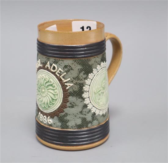 An unusual Doulton Lambeth tortoise & hare mug, inscribed Pearl Adelia 1886, H. 12.5cm